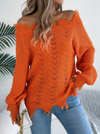 Woman wearing an orange off-the-shoulder distressed knit sweater with light wash jeans