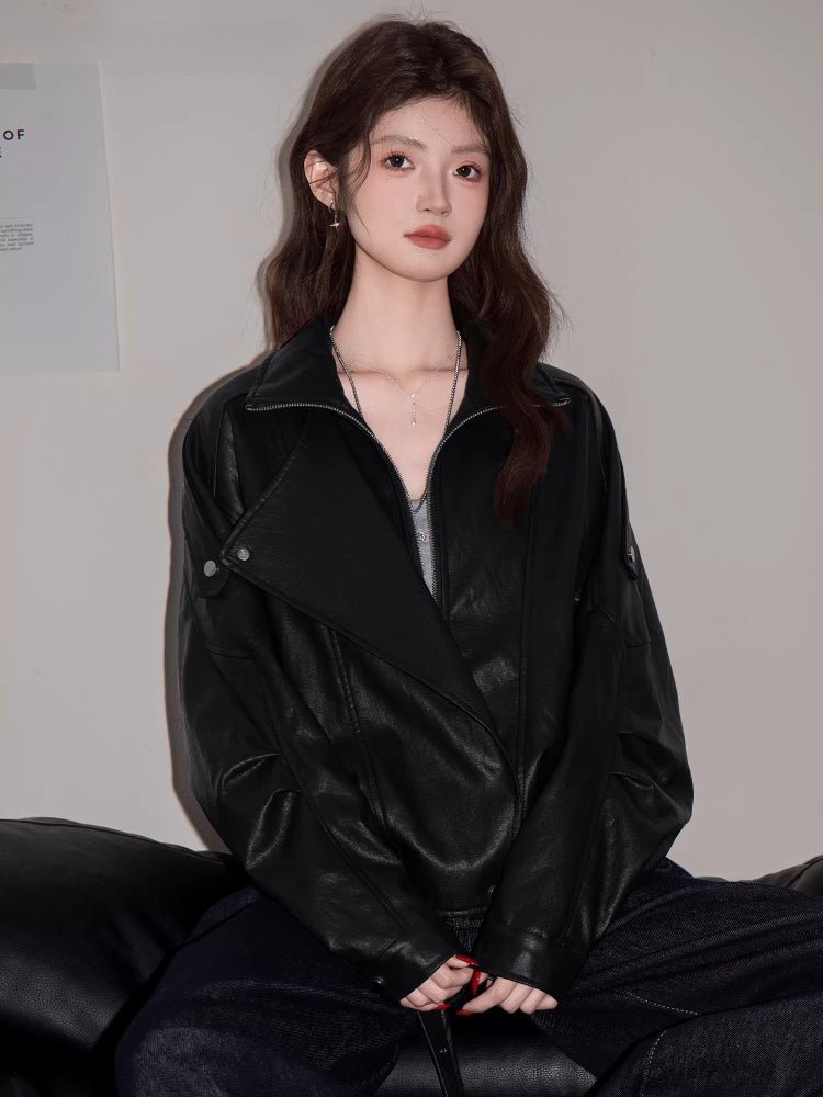 Model wearing a black faux leather bomber jacket with an asymmetrical zipper and lapel collar. Main image