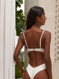 Rear view of a woman wearing a white one-piece swimsuit, showcasing adjustable straps and a high-cut leg.