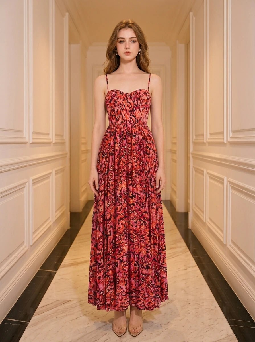 Woman wearing a red floral print maxi dress with spaghetti straps and a sweetheart neckline, standing in a hallway.