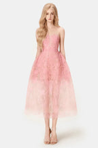 Woman wearing a pink strapless lace tea-length A-line dress