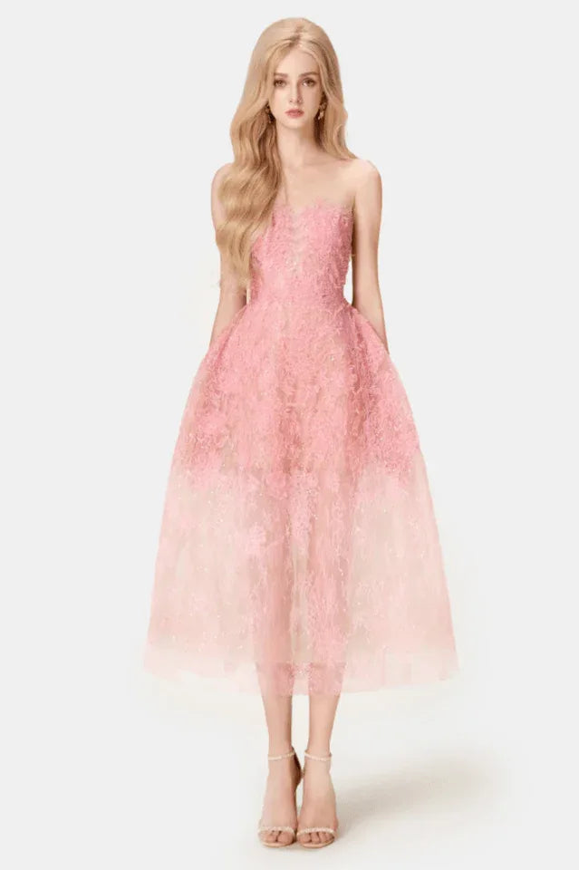 Woman wearing a pink strapless lace tea-length A-line dress