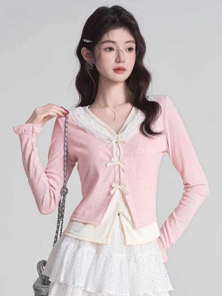 Close-up of a pink knit cardigan with delicate bow details.