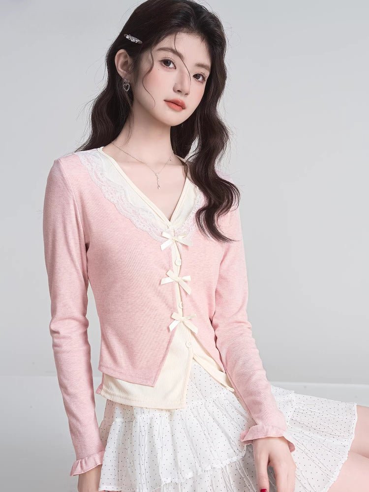 Full body shot of a woman in a pink cardigan and a white tiered skirt.