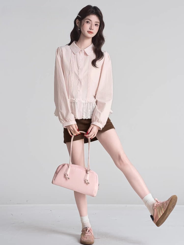 Full body shot of a woman wearing a pink peplum blouse, brown skirt, and sneakers.