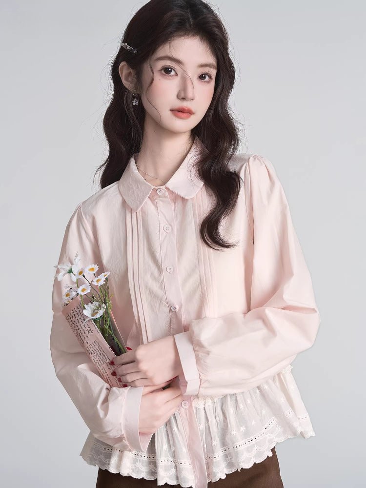 Woman holding a bouquet of white flowers while wearing a pink peplum blouse.