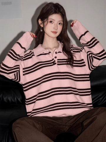 Woman wearing a pink and brown striped polo sweater