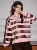 Woman modeling a pink and brown striped polo sweater