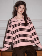 Woman posing in a pink and brown striped polo sweater