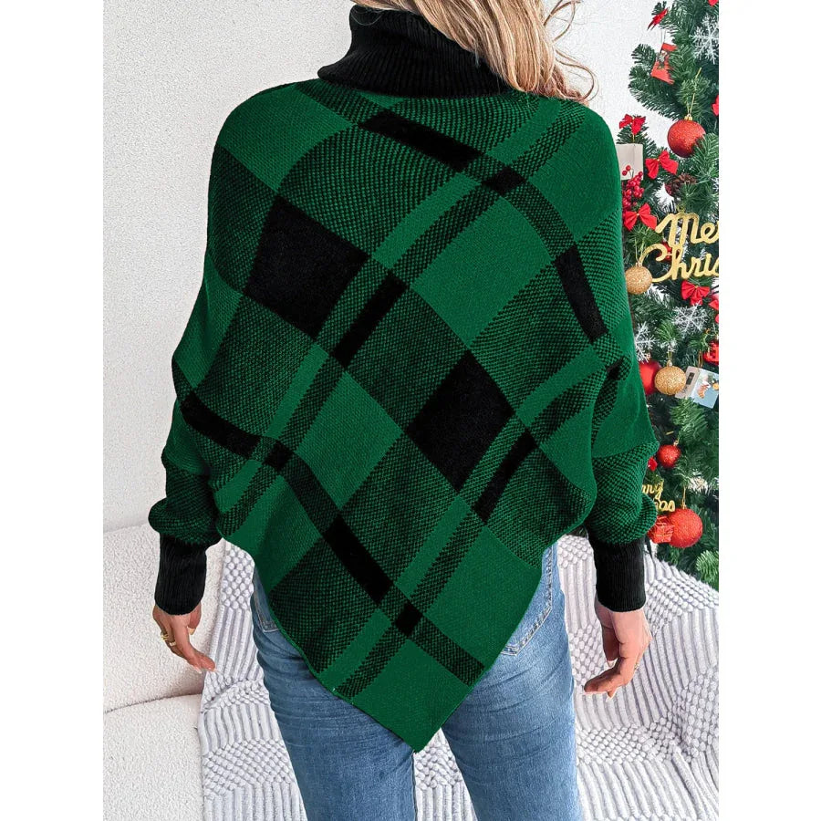 Back view of a woman wearing a green and black plaid turtleneck poncho sweater