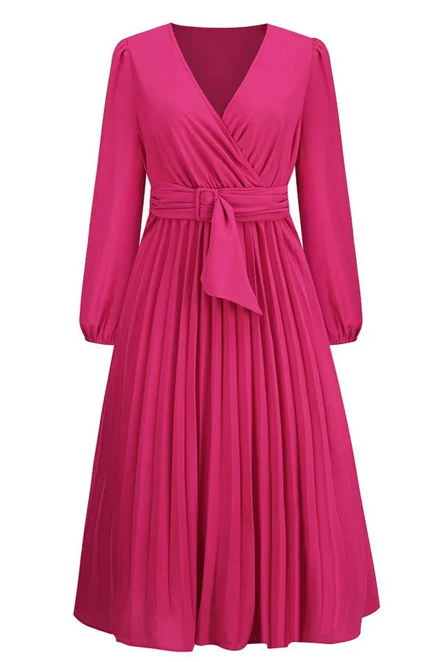 Front view of a pink long-sleeved midi wrap dress with accordion pleats and a belt.