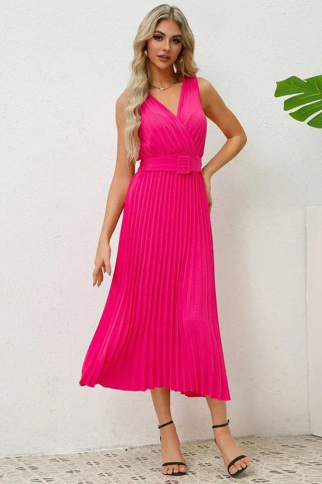 Woman wearing a bright pink sleeveless V-neck midi dress with a pleated skirt and matching belt. Main image