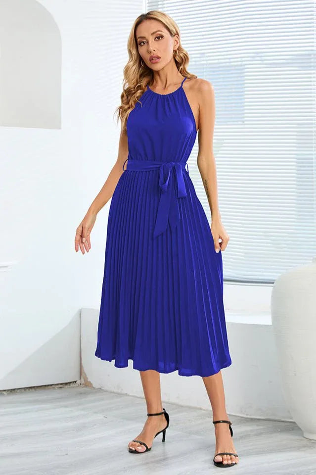 Front view of a royal blue pleated halter neck midi dress with a self-tie belt
