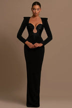 Woman wearing a black formal gown with structured shoulders and a plunging, embellished neckline.