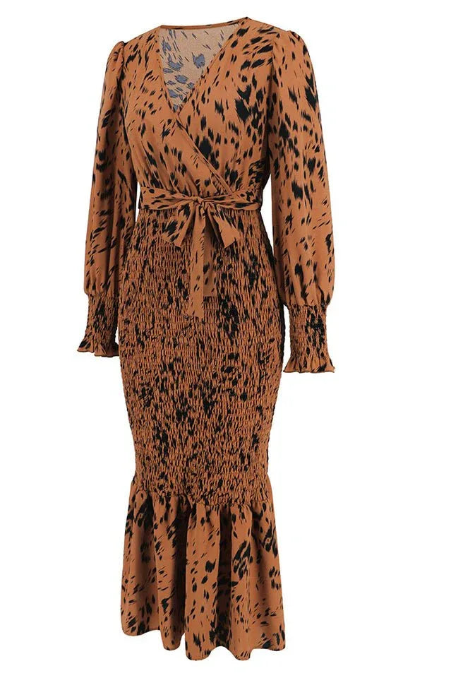 angled product shot of a brown and black leopard print long sleeve smocked midi dress with a tie waist