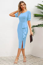woman posing in light blue sheath dress with ruffle detail