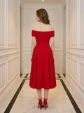 Back view of a woman in a red off-the-shoulder midi dress.