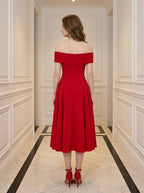 Back view of a woman in a red off-the-shoulder midi dress.