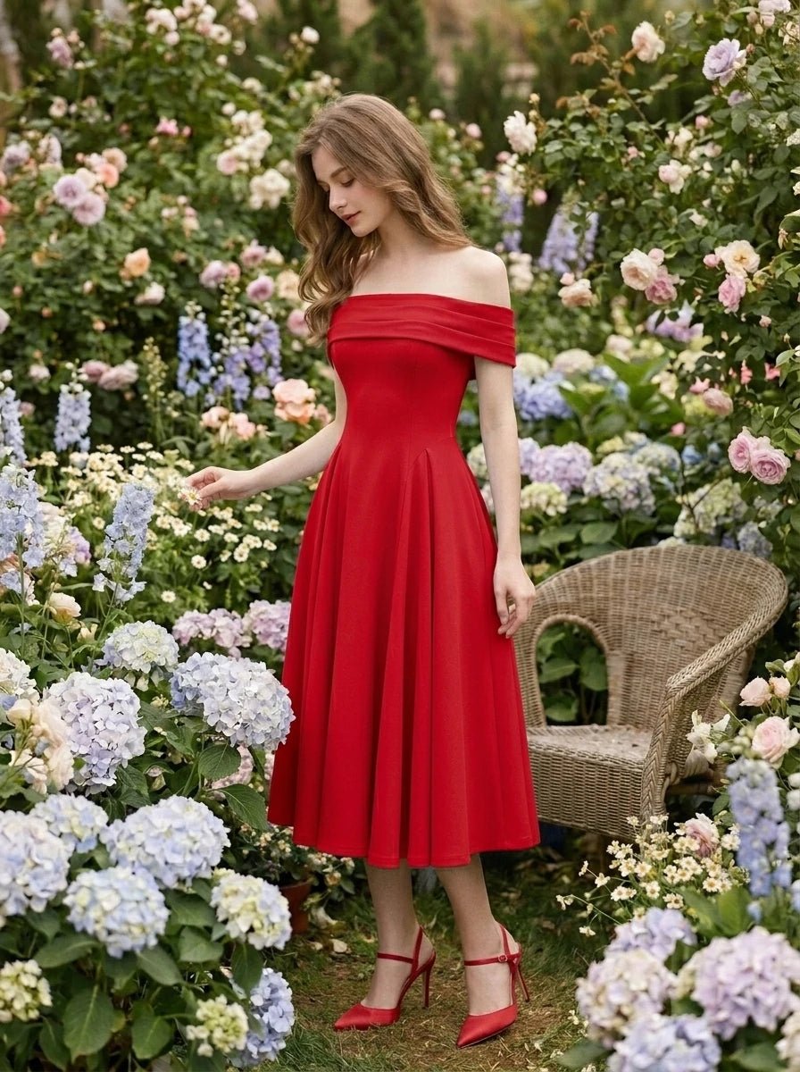 Woman in a red off-the-shoulder midi dress posing in a garden with flowers.