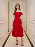 Woman wearing a red off-the-shoulder midi dress with cap sleeves.