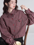 Front view of the woman in the plaid cropped shirt, highlighting the button-up front and drawstring hem.