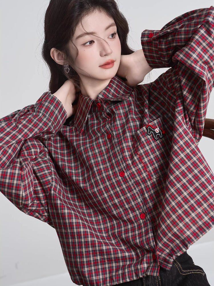 Model posing with hands behind her head, showcasing the fit and details of the plaid cropped shirt.