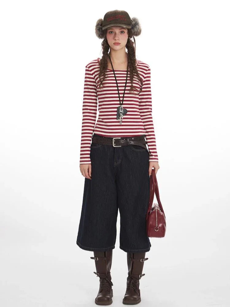 Woman wearing a red and white striped long-sleeve top and dark wash wide-leg culottes