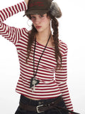 Detail shot of the woman's face, hair, and striped top neckline