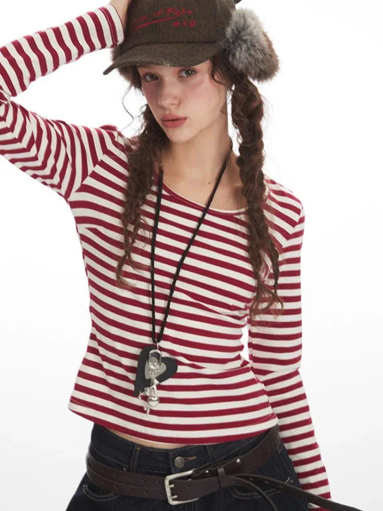 Detail shot of the woman's face, hair, and striped top neckline