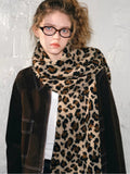 Woman wearing a leopard print knit scarf