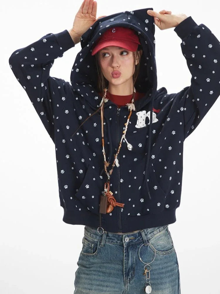 Woman posing with the hood of her navy blue zip-up hoodie up