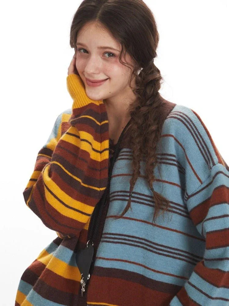 Close-up of a woman's face and shoulder, showcasing the texture and stripe pattern of the knit cardigan.