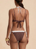 Back view of a woman in a brown and white polka dot bikini with adjustable straps and tie closures.