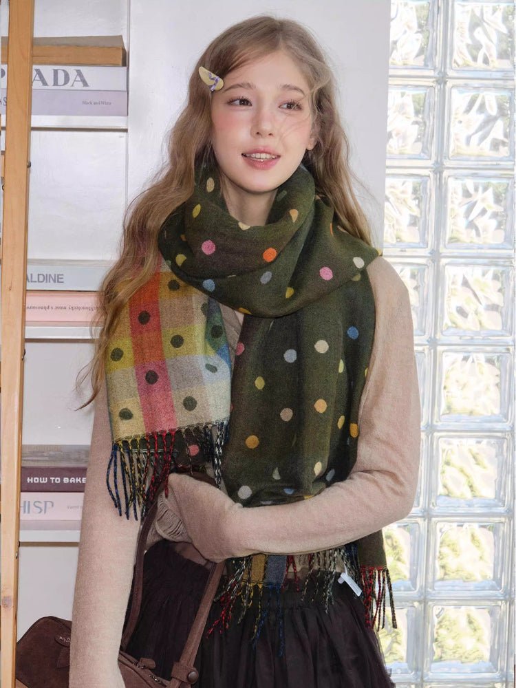 Woman wearing a green polka dot scarf with colorful dots and fringe trim
