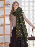 Full body shot of a woman in a polka dot scarf and a beige cardigan