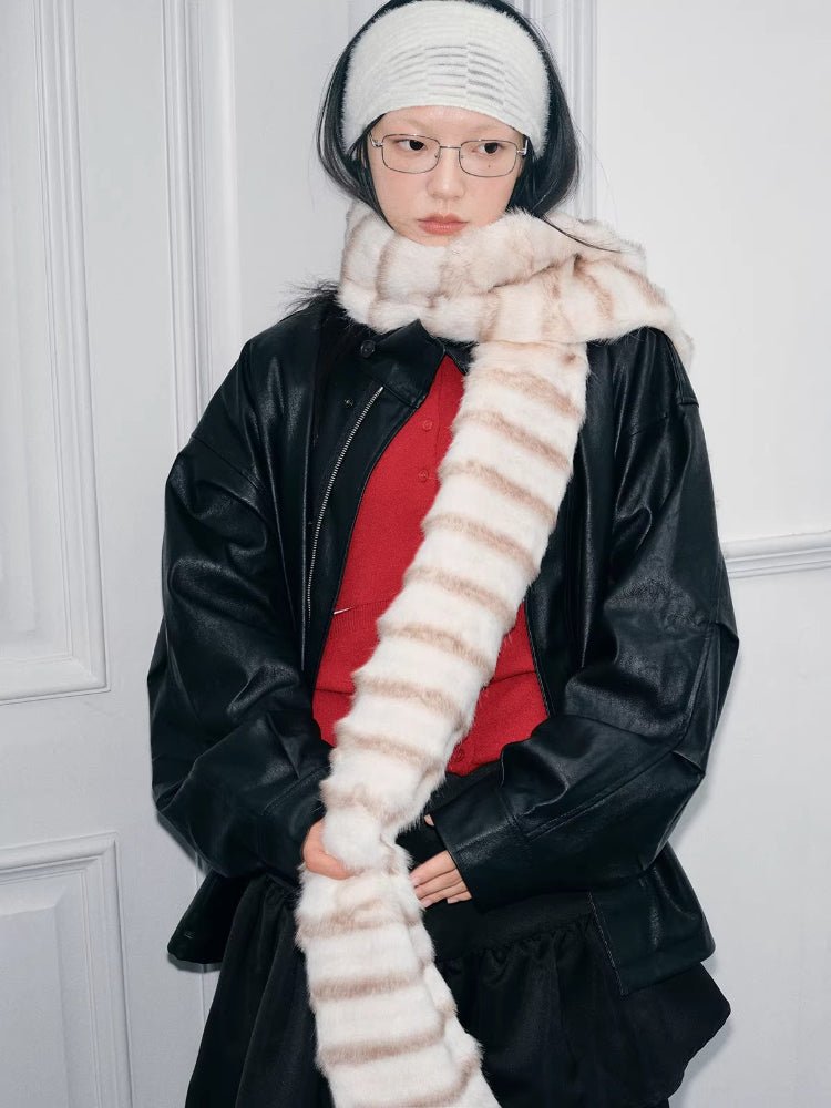 Close-up of a woman with a cream and brown striped faux fur scarf draped around her neck.