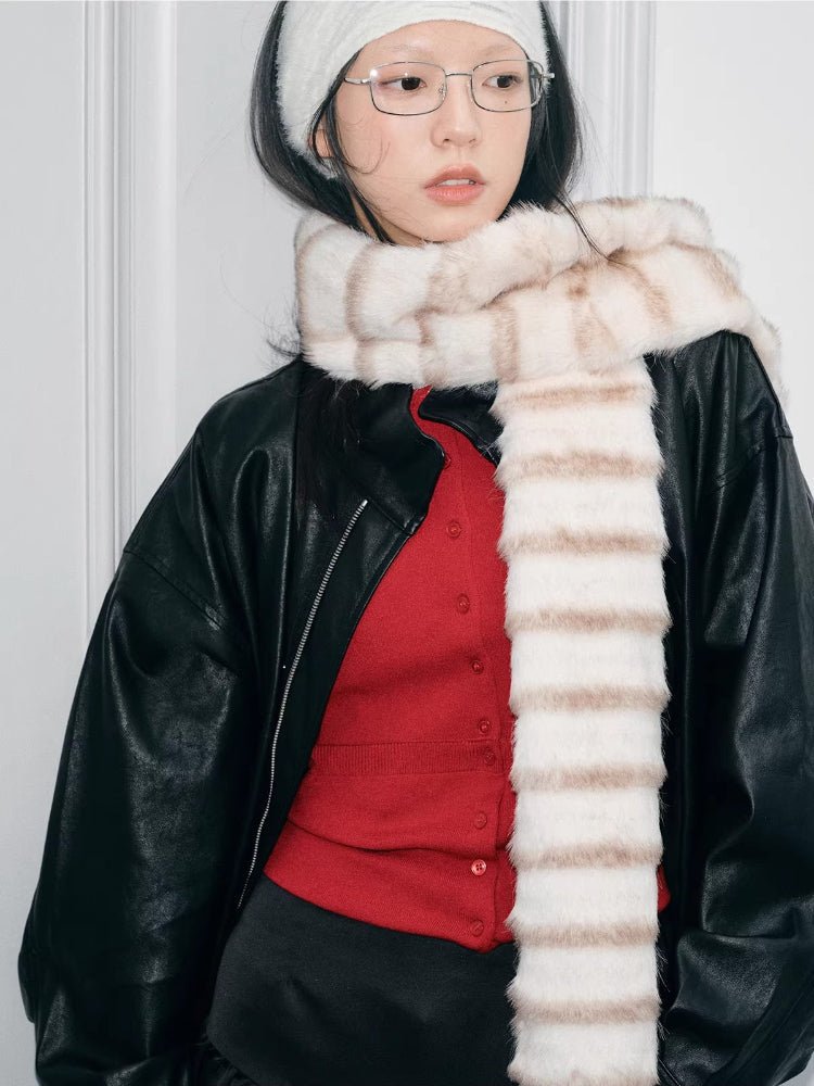 Profile shot of a person wearing a cream and brown striped faux fur scarf.