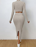 Back view of a woman in a beige ribbed knit set, highlighting the long sleeves and skirt slit.