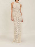 Woman wearing an ivory knit maxi dress with a halter neckline and chevron pattern