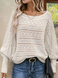 Front view of a cream open-knit sweater with diamond pattern details.