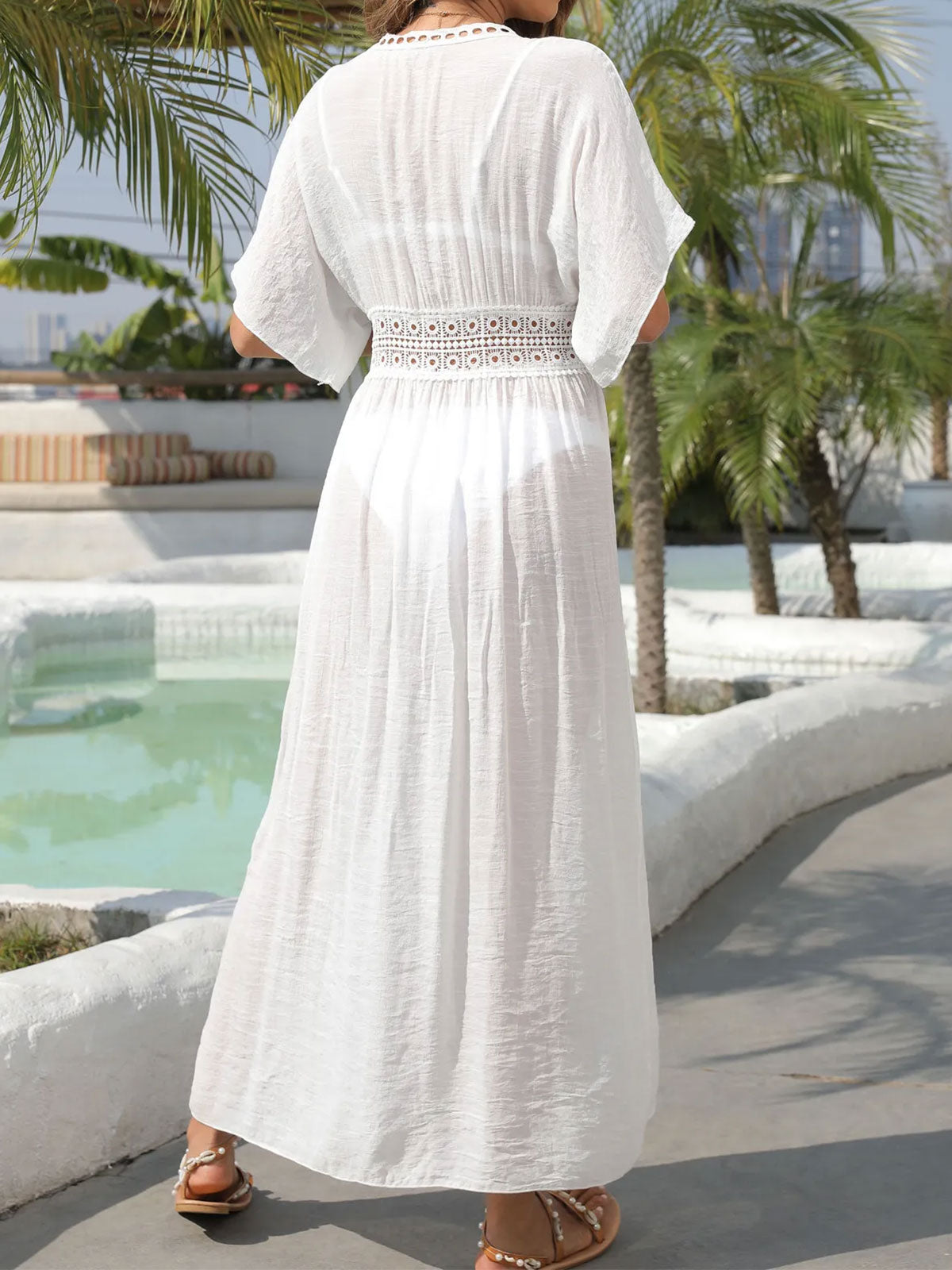 Back view of a woman in a white maxi beach cover-up