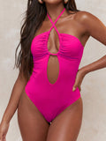Hot pink one-piece swimsuit with keyhole detail and halter neck