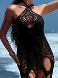 Close-up of a woman wearing a black crochet knit dress with intricate patterns and cut-outs.