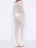 Back view of a woman in a white crochet knit maxi dress with long sleeves and a maxi length.