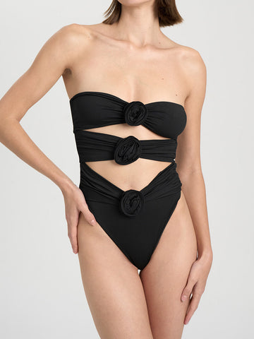 Black strapless one-piece swimsuit with floral embellishments and cut-out detail