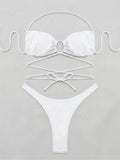 Flat lay of a white bikini set with halter top and high-cut bottoms