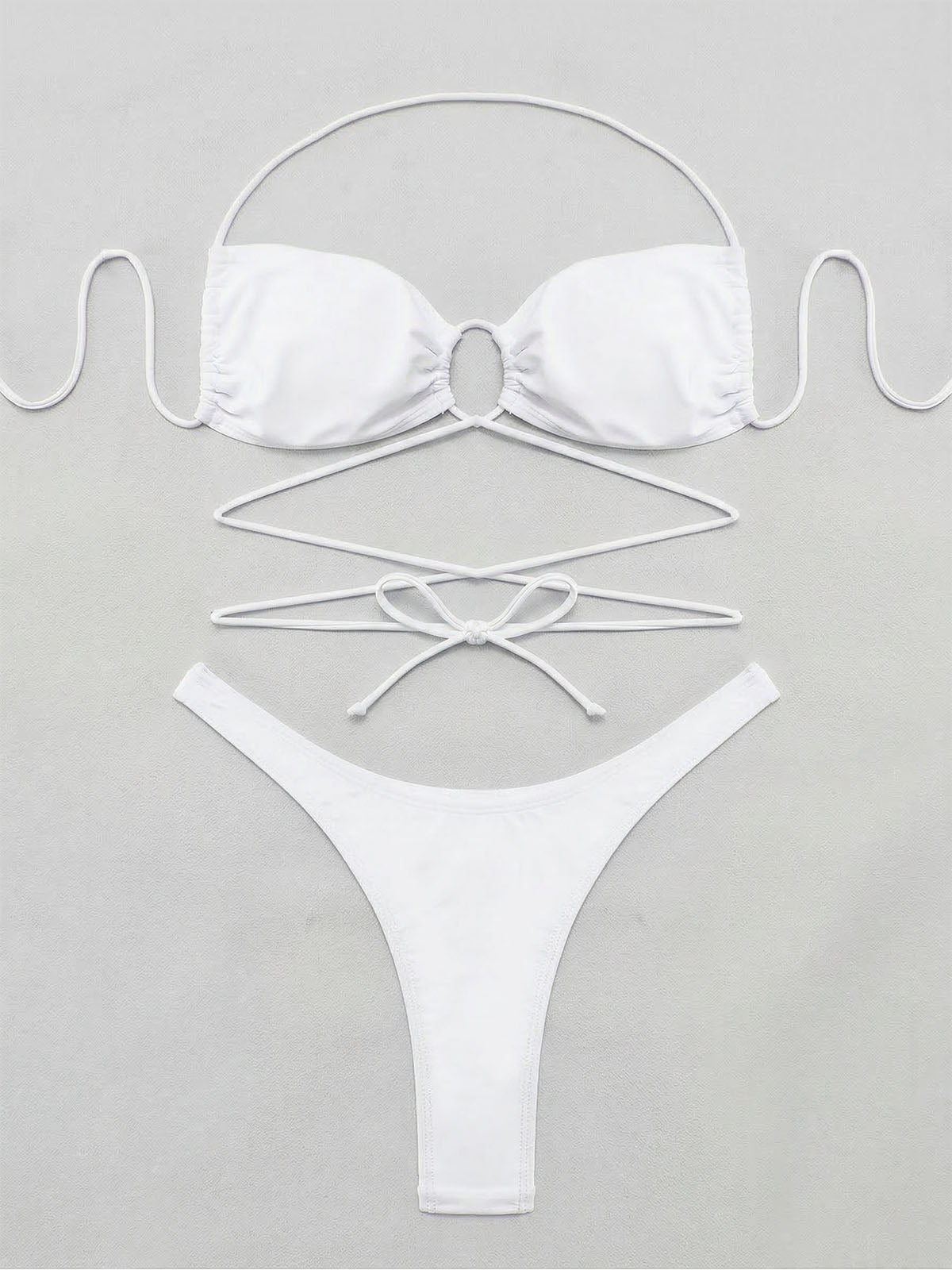 Flat lay of a white bikini set with halter top and high-cut bottoms