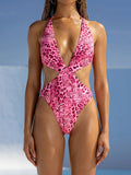 Pink leopard print one-piece swimsuit with plunge halter neckline and cut-out sides