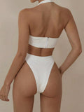 Back view of a woman wearing a white one-piece swimsuit with a zipper closure