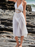 Full shot of a woman in a white beach dress with a V-neckline and flowing skirt